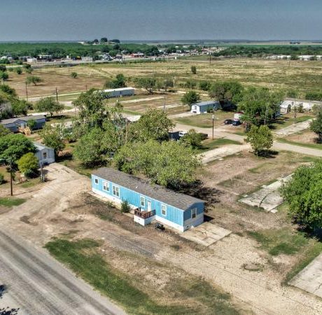 A well-maintained mobile home with a neatly landscaped front yard, representing the available rentals at Sunset Mobile Home Park in Hondo, TX.